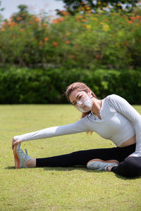 Beautiful chinese girl wearing n95 face mask while working out