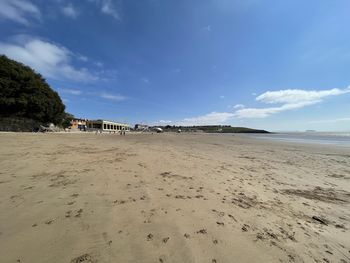 Scenic view of beach against blue sky