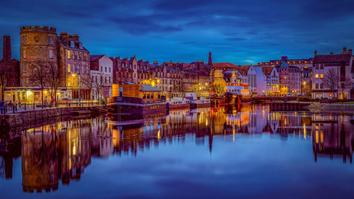 Reflection of illuminated buildings in water at night