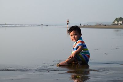 Woman standing by sea