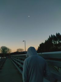 Rear view of man on road against sky