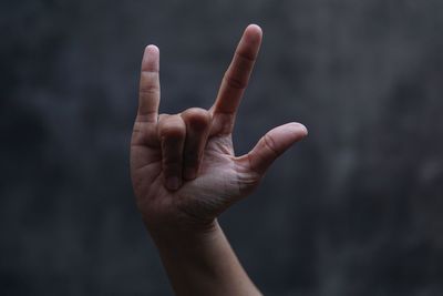 Close-up of human hand against black background