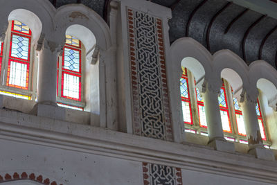 Low angle view of building seen through glass window