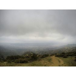 Scenic view of landscape against cloudy sky