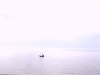 Sailboat sailing on sea against sky