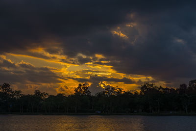 Scenic view of lake against orange sky