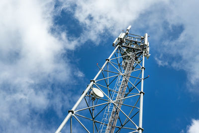 Low angle view of electricity pylon against sky