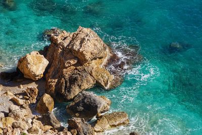 High angle view of rocks in sea