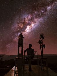 Full length rear view of man standing at night