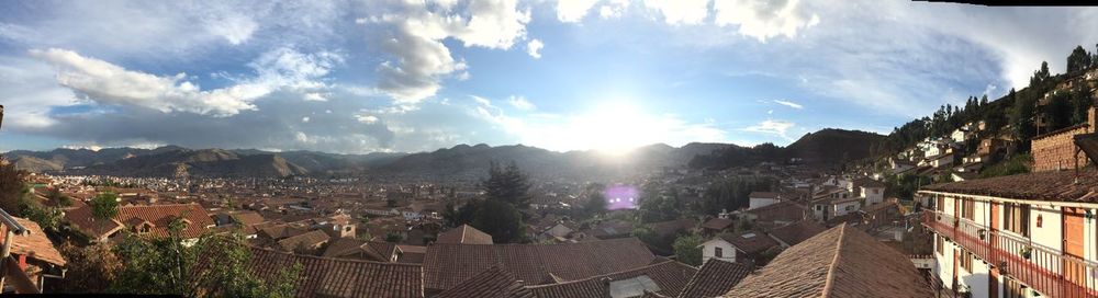 Panoramic view of buildings and trees against sky