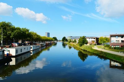 View of river in town against sky