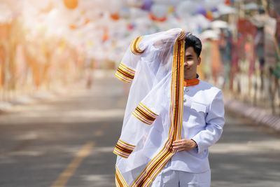 Rear view of woman holding umbrella