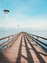 Pier over sea against sky