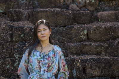 Woman standing against wall