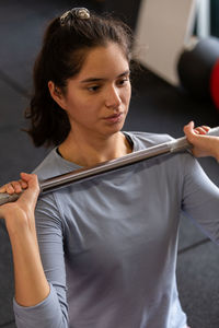 Portrait of young woman exercising in gym