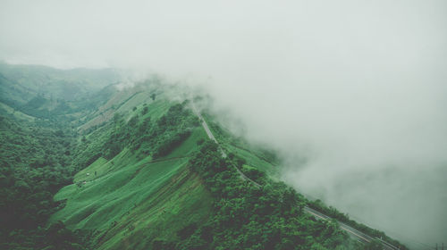 Scenic view of landscape against sky during foggy weather