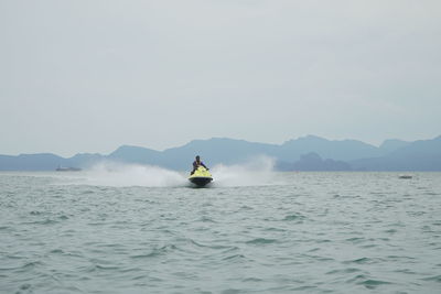 Man on sea against sky