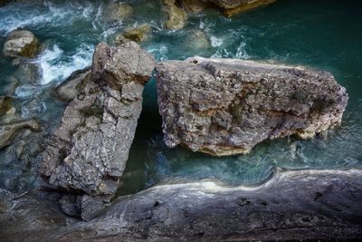 High angle view of rocks in sea