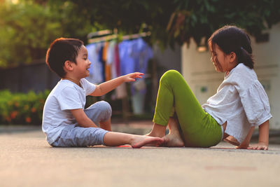 Siblings sitting outdoors
