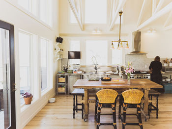 Rear view of woman working in kitchen at home