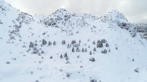 Scenic view of snow covered mountains against sky