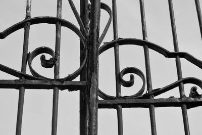 Low angle view of rusty metal against sky