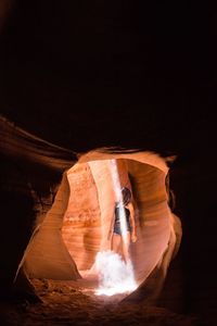 Woman standing in cave