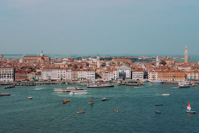 View of city by sea against sky