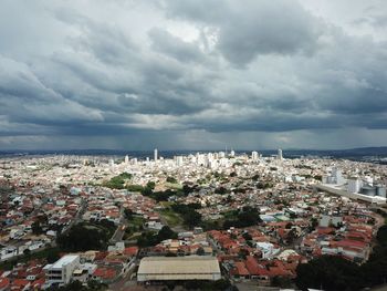 High angle view of townscape by sea against sky