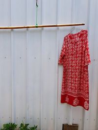 Close-up of clothes drying against white wall