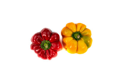 High angle view of red bell peppers on white background