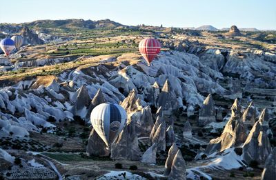 Hot air balloon flying over rocks