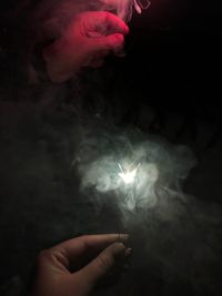 Close-up of hand holding illuminated light