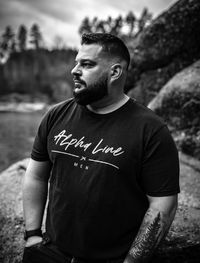 Man looking away while standing outdoors