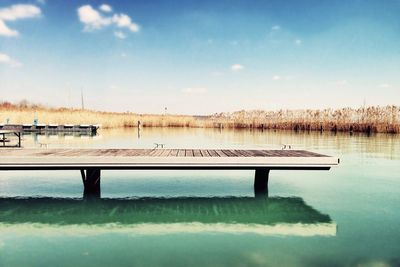 Scenic view of calm lake against sky