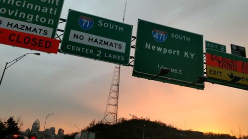 Low angle view of road sign against sky