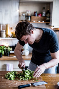 Man preparing food in kitchen at home