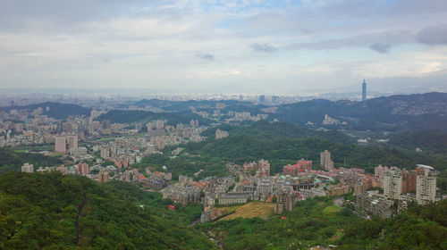 Cityscape against cloudy sky