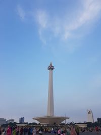 Low angle view of monument and buildings against sky