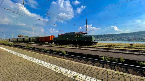 Train on railroad tracks against sky