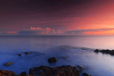 Scenic view of sea against sky at sunset