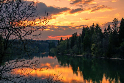 Scenic view of lake against sky at sunset