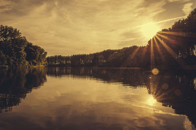 Scenic view of lake at sunset