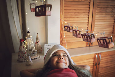 Portrait of young woman sitting at home