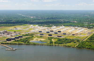 High angle view of river amidst cityscape against sky