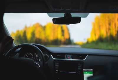 Car moving on road seen through windshield