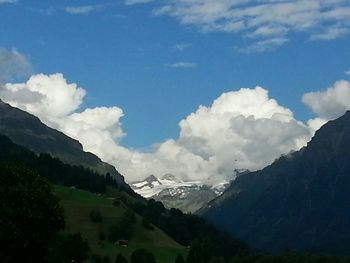 Scenic view of mountains against cloudy sky