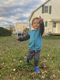 Low section of woman walking on field