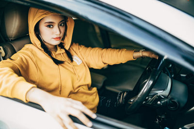 Portrait of woman sitting in car
