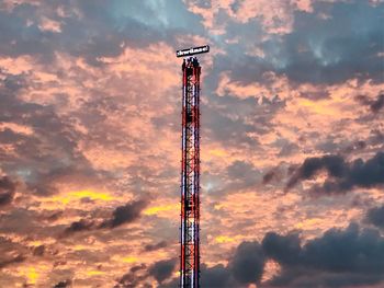 Low angle view of communications tower against sky during sunset